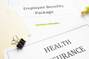 Papers that read "Emplouee Benefits Package", "Summary of Benefits", and "sunwin Insurance". There is a yellow highlighter and a binder clip on top of the papers.